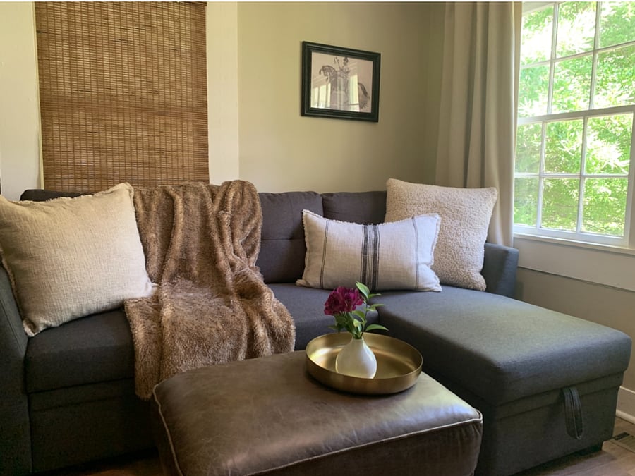 Sofa in the cozy living area. Room darkening linen drapery.