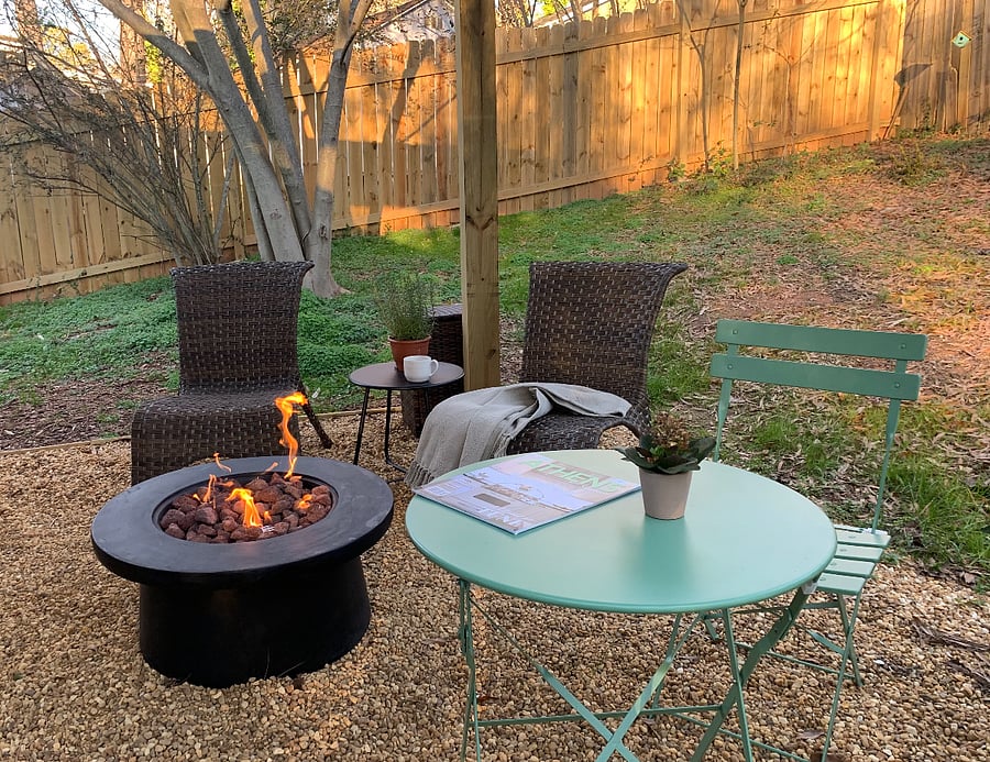Firepit table on the covered gravel patio