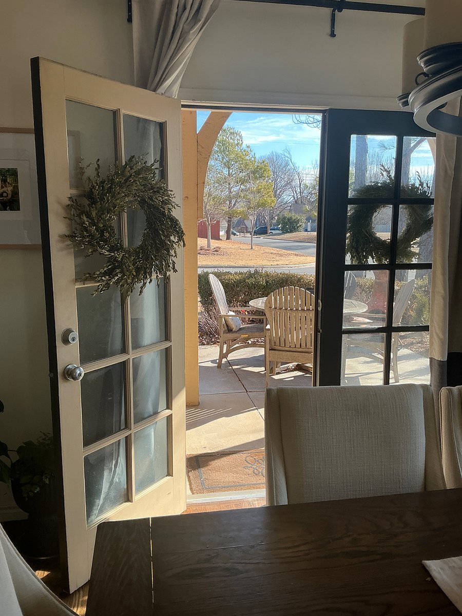 French doors of the Dining Room opens to the patio with the view of the peaceful pond
