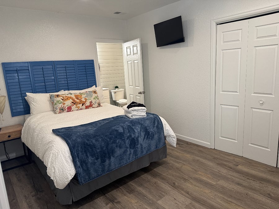 Primary bedroom (Queen Bed) with attached bathroom w/ walk in shower & closet