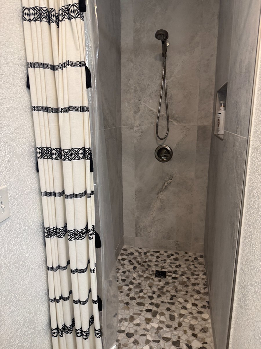Walk in shower attached to primary bedroom