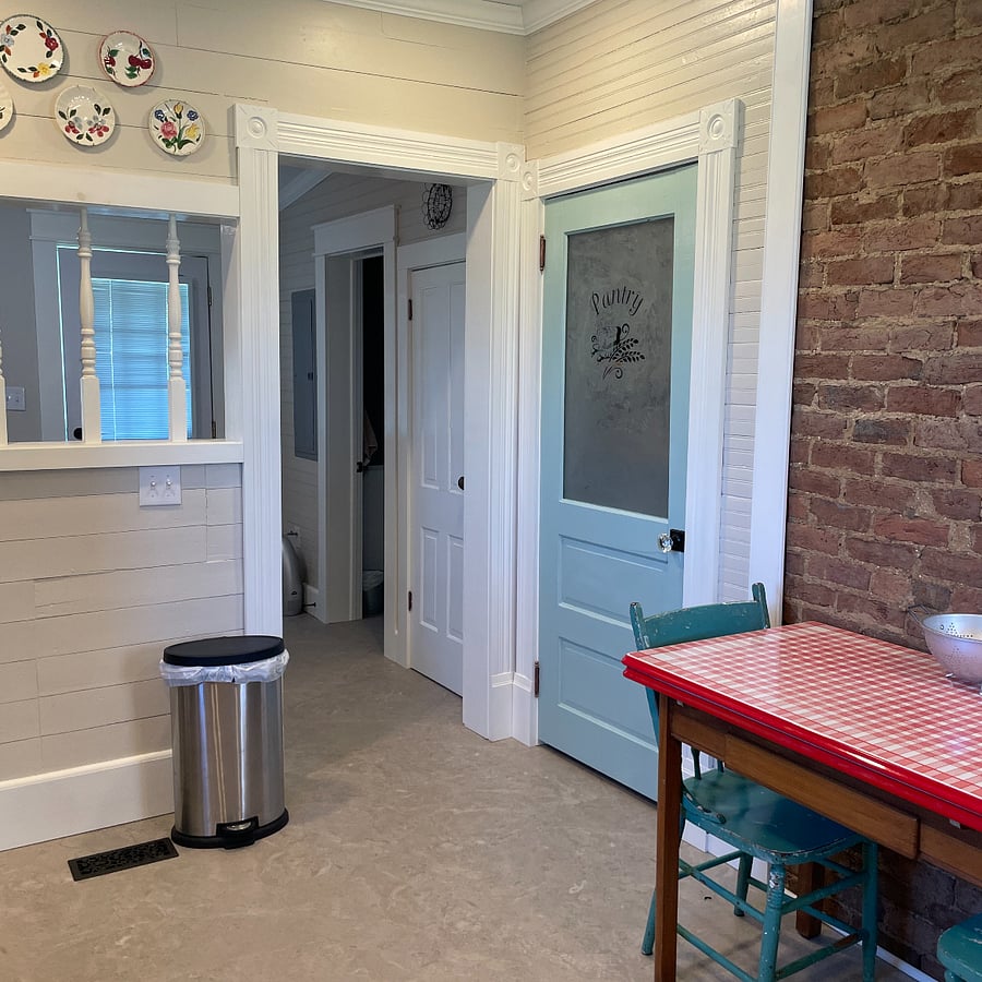 Kitchen has a roomy pantry for extra storage.