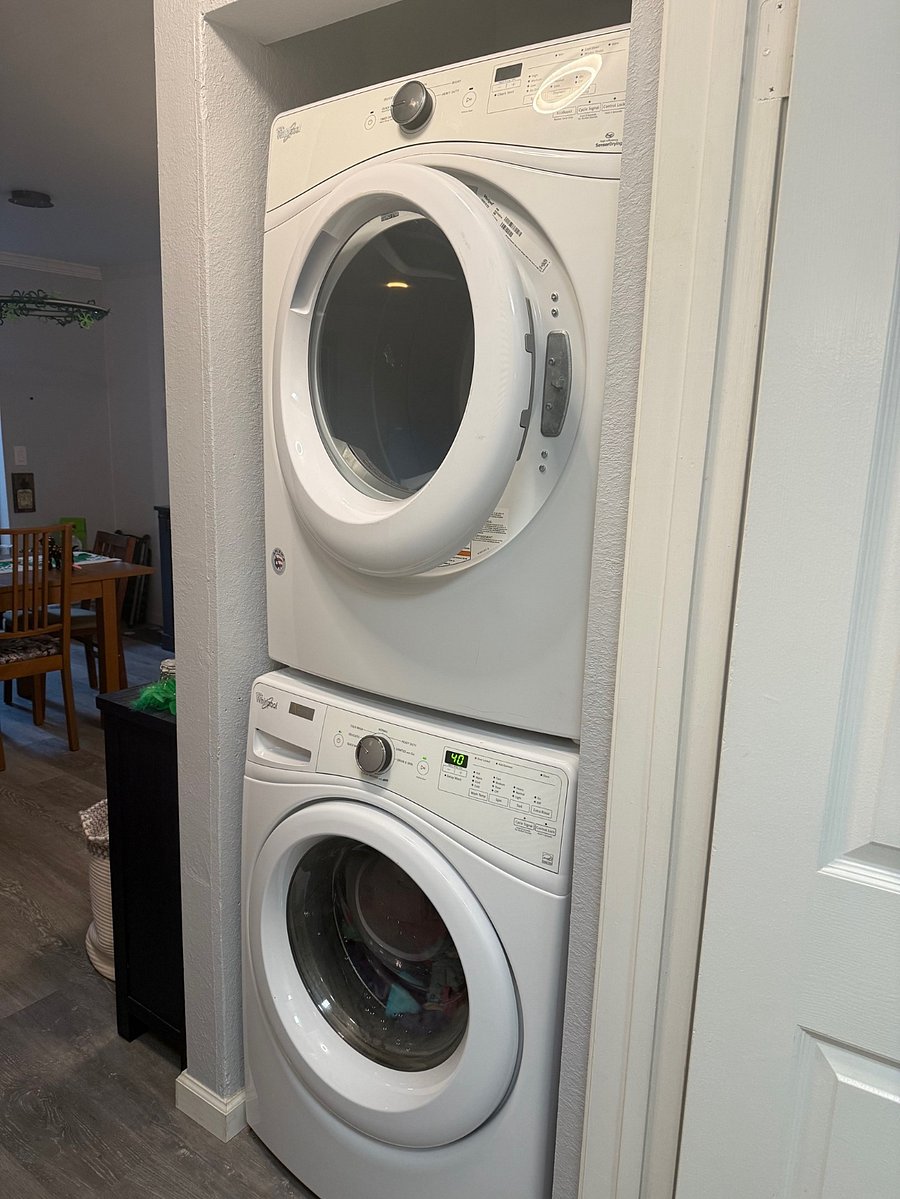 Shared washer/dryer in hallway outside of private bedroom.