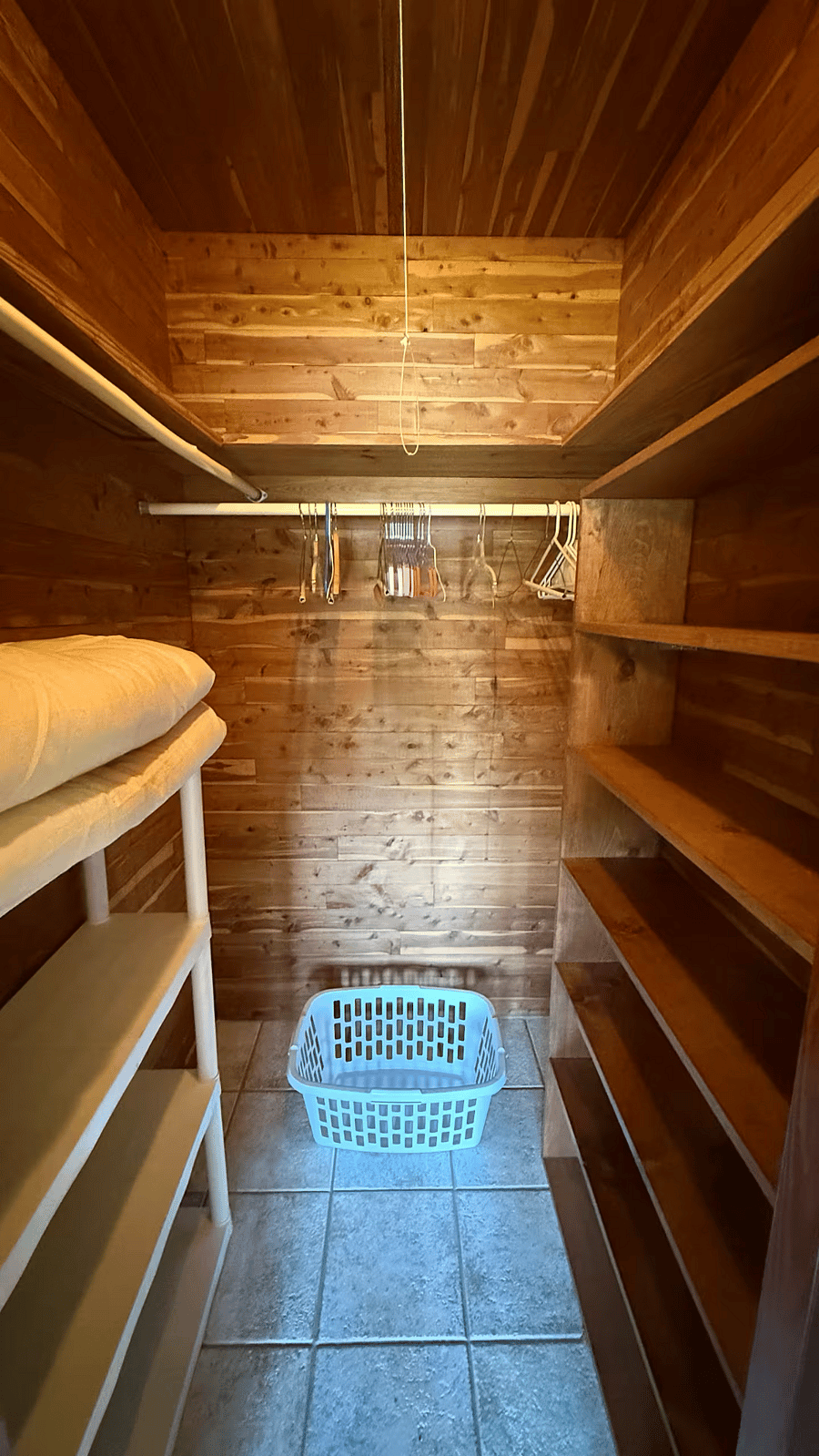 Enjoy an expansive walk-in closet crafted from stunning heart of pine wood. With ample shelving and room for organization, the rich, warm tones create a luxurious and functional space to keep your wardrobe tidy and your living area clutter-free.