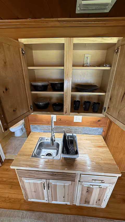 This sink is equipped with a garbage disposal. The beautiful cabinetry surrounding the sink is elegant, with modern finishes to complement the overall design. The under-cabinet lighting casts a soft, ambient glow providing functional illumination!