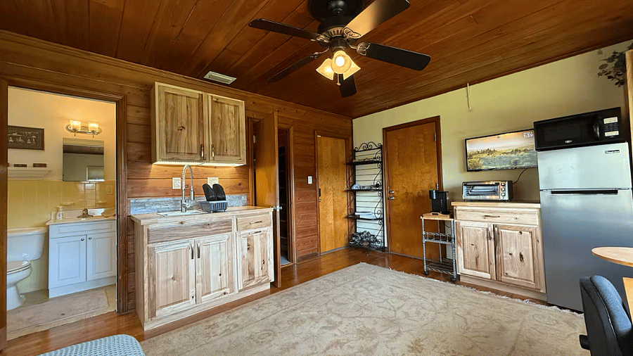 The kitchen includes everything you need to prepare meals, from sleek appliances to quality cookware. A cozy dining nook offers the perfect spot for enjoying your meals while gazing at the water. The sleeping area is a haven of organic comfort.