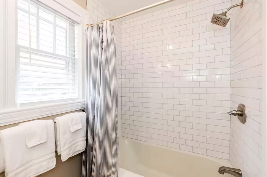 Bathroom with bathtub and basic toiletries provided.
