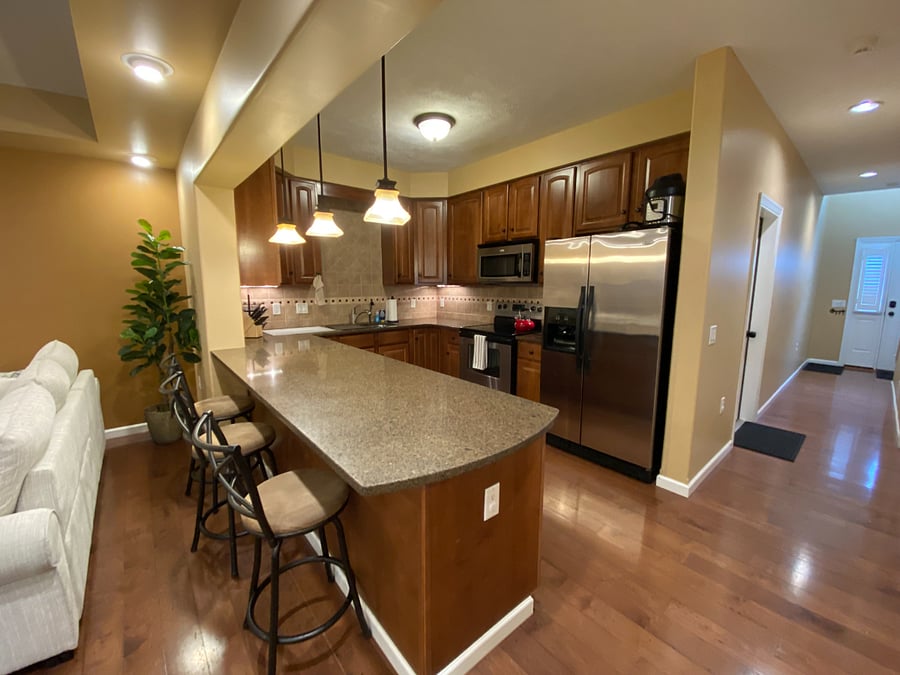 The modern kitchen boasts sleek
quartz countertops and a convenient large peninsula, offering ample workspace. You'll find a complete set of full-sized stainless
steel appliances, including a refrigerator, oven/stovetop, microwave, and dishwasher. For your morning routine, a coffee maker
is provided. The kitchen is also equipped with essential cookware, bakeware, dishes, glasses, and utensils, ensuring you have
everything you need to feel right at home.