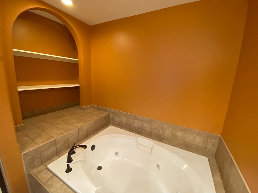 The primary bathroom is designed for both comfort and functionality, offering a double vanity, a relaxing jacuzzi tub, a separate shower, and a private toilet area.