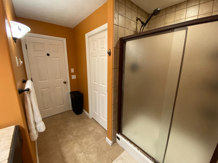 The primary bathroom is designed for both comfort and functionality, offering a double vanity, a relaxing jacuzzi tub, a separate shower, and a private toilet area.
