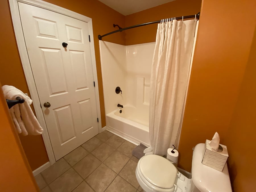 Located just down the hall from the secondary bedroom, this dedicated bathroom offers convenience and privacy. It's a full bathroom, complete with a sink, toilet, and a tub/shower combination for your guest's comfort and ease.