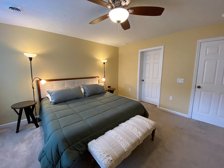 Serene and spacious, the tranquil primary bedroom has a king bed, ensuite, dual closets, a ceiling fan, and easy access to the laundry area.