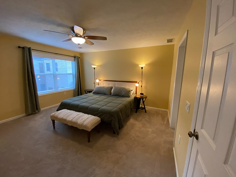 Serene and spacious, the tranquil primary bedroom has a king bed, ensuite, dual closets, a ceiling fan, and easy access to the laundry area.
