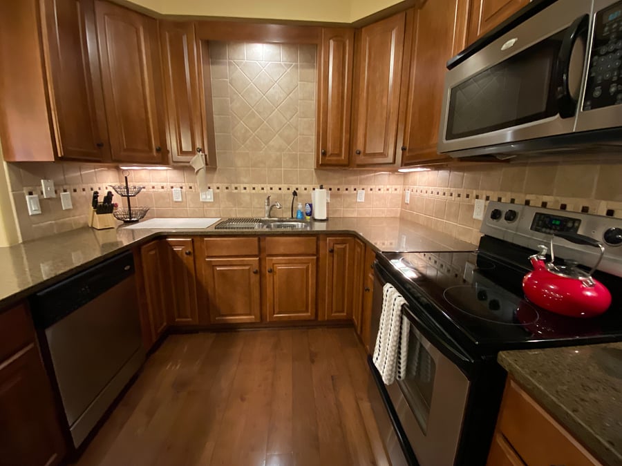 The modern kitchen boasts sleek
quartz countertops and a convenient large peninsula, offering ample workspace. You'll find a complete set of full-sized stainless
steel appliances, including a refrigerator, oven/stovetop, microwave, and dishwasher. For your morning routine, a coffee maker
is provided. The kitchen is also equipped with essential cookware, bakeware, dishes, glasses, and utensils, ensuring you have
everything you need to feel right at home.