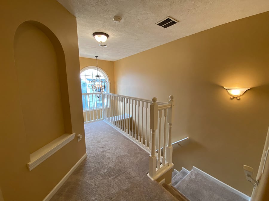 Serving as a central access point to the bedrooms, the second-floor hallway also provides a visual connection to the home's inviting entrance.