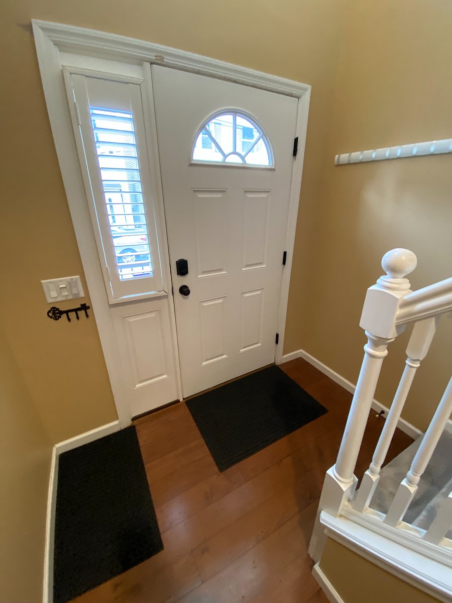 Stepping inside, you'll find a compact yet bright entryway. Despite its size, the soaring ceiling opens up to the second floor, allowing an abundance of natural light to flood the space. From here, you have direct access to the open-concept living, dining, and kitchen area, as well as a convenient half bath. The stairway leading to the second-floor bedrooms and bathrooms is also readily accessible from the entryway.