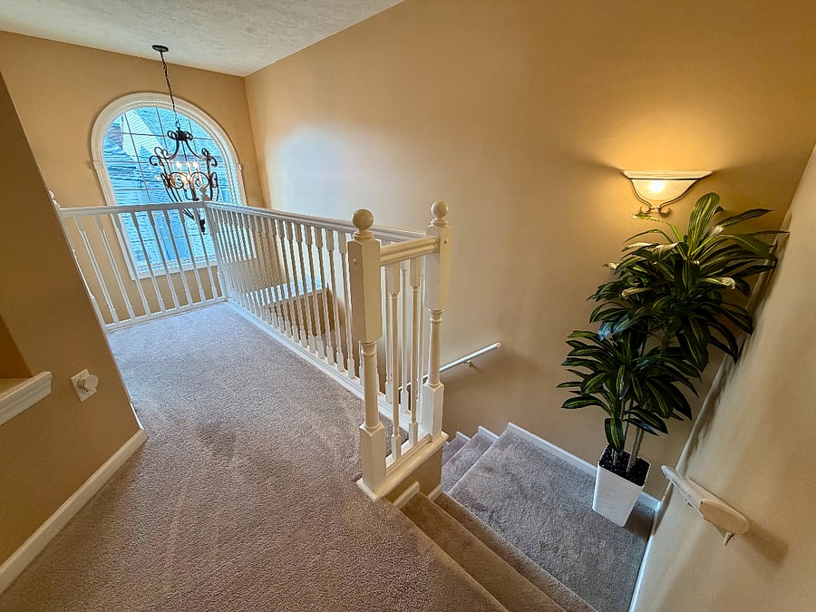 Serving as a central access point to the bedrooms, the second-floor hallway also provides a visual connection to the home's inviting entrance.