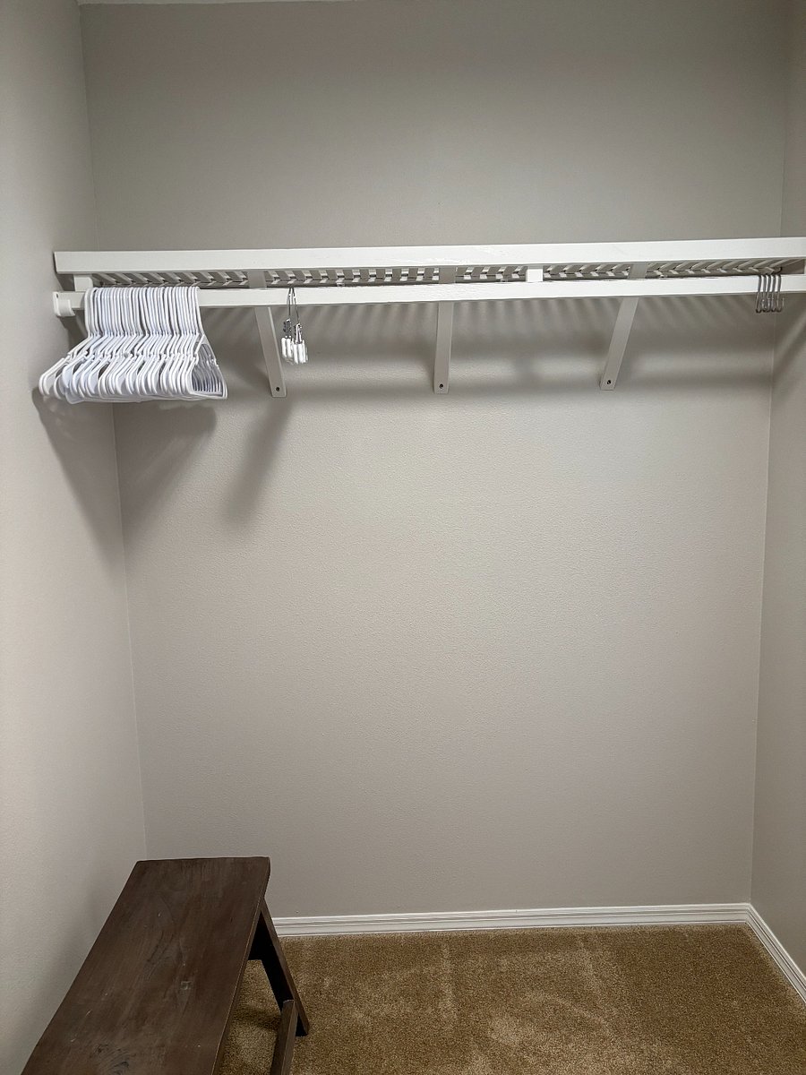 MASTER CLOSET: Ample storage on solid wood shelves.