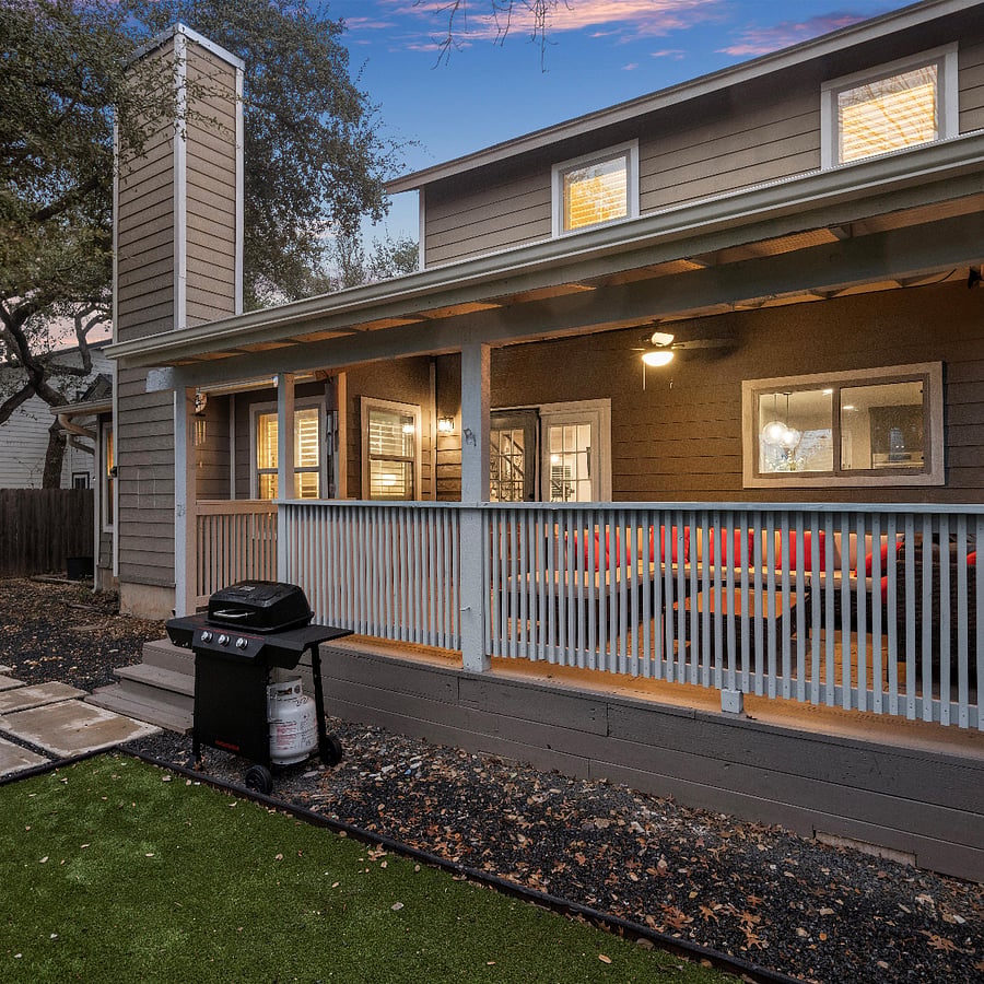Back patio with furniture set and propane grill