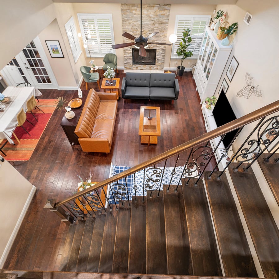 Stairs up to master bedroom and view of the downstairs living room