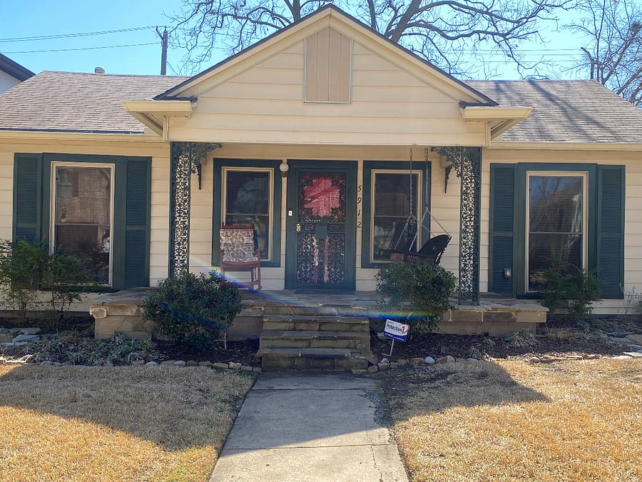 Front elevation with porch swing and rocker