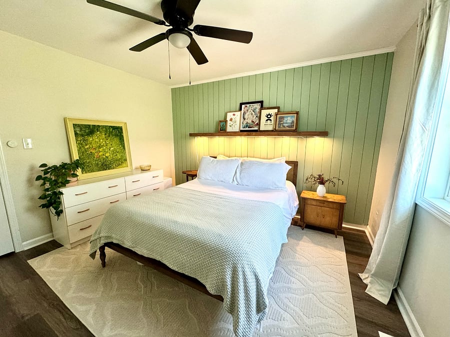 Second bedroom with queen size bed & newly repainted walls with a soothing sage-green accent wall 