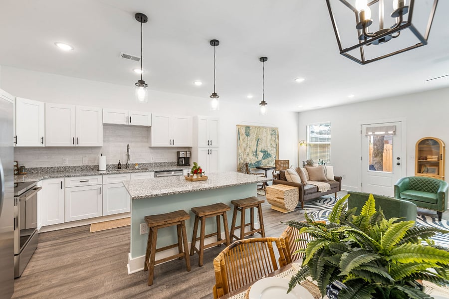 Open concept living with kitchen, dining, and living room in one spacious area.