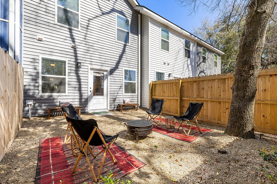 There's plentiful backyard seating with benches and chairs surrounding the grilling firepit.