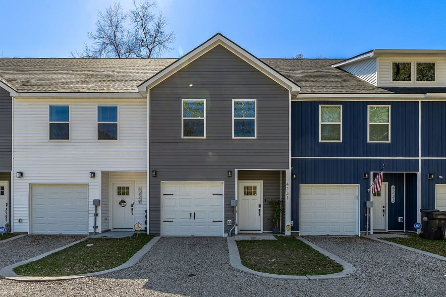The gray home with carriage house garage door is "Charleston Expedition Base Camp." There is also one parking space in front of the garage for your use.