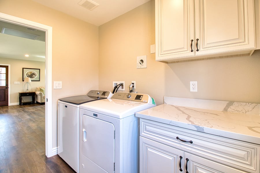 In home laundry room with large washer and dryer.