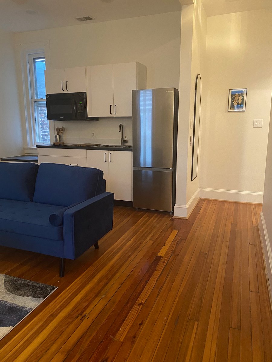 Around the corner from the living area is a hallway leading to bedroom and bathroom