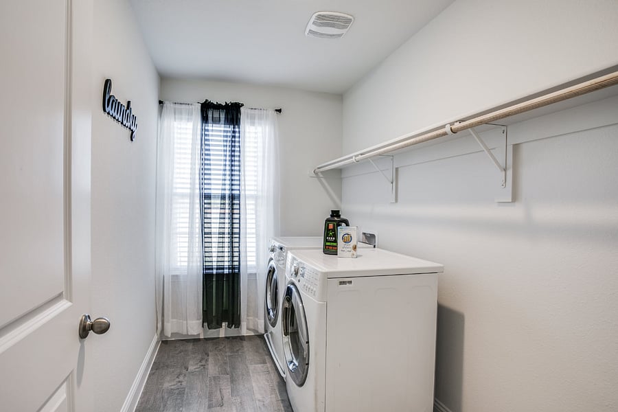 Full size washer and dryer, in private laundry room in house.