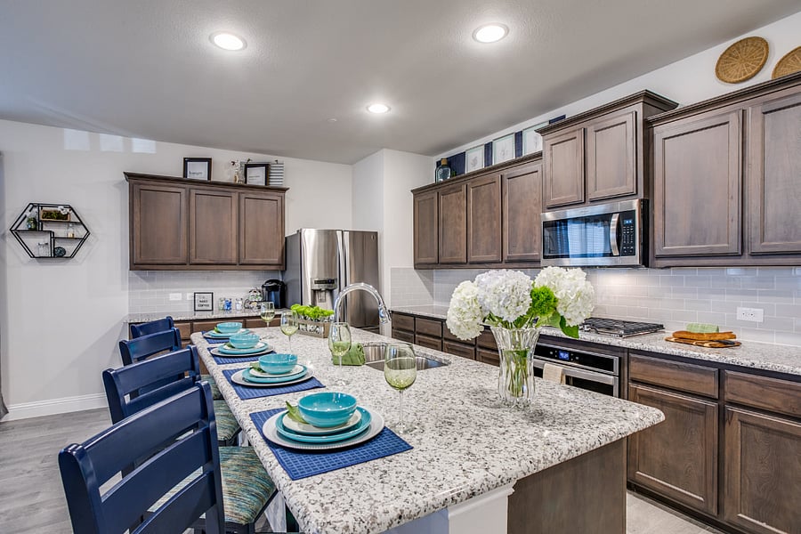 Open space kitchen with stainless steel appliances, granite counters, and gas range.