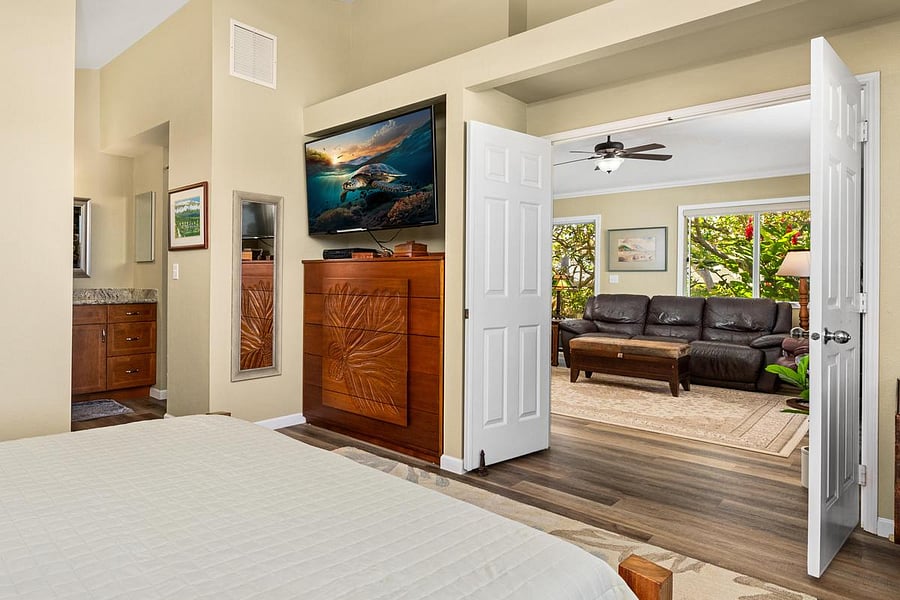 Primary bedroom has french doors opening onto the great room and sliders opening onto the lanai.