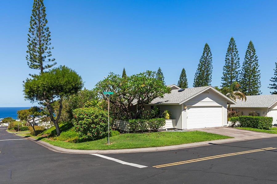 Corner unit with garage and tropical gardens.