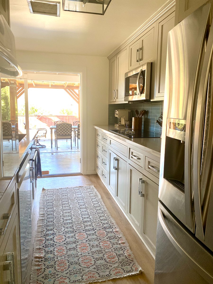 Galley kitchen open to the back patio