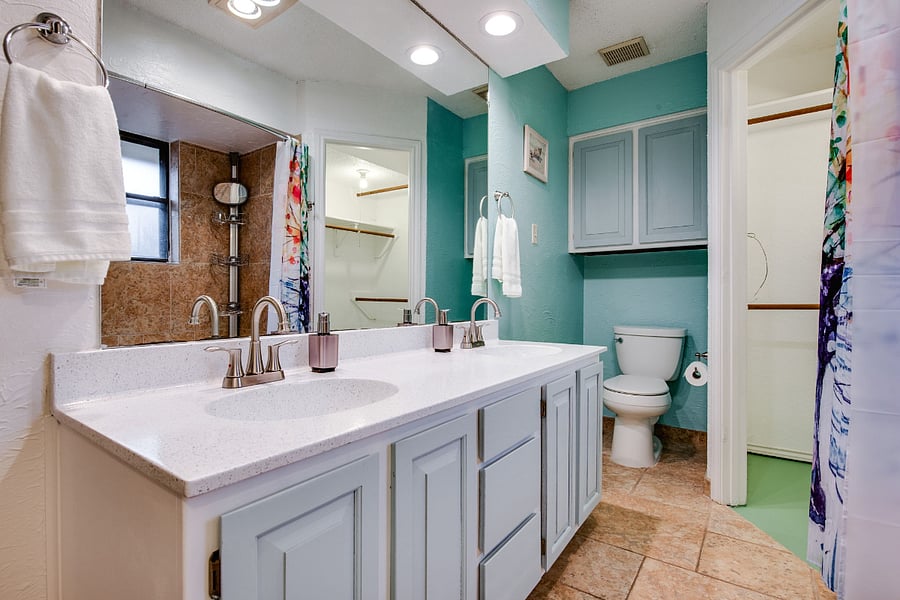 Master bathroom, with 2 sinks, tub,, shower, and 2x walk-in closets