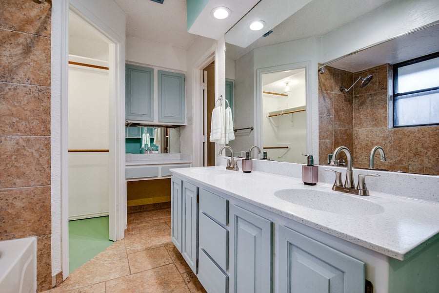 Master bathroom, with 2 sinks, tub,, shower, and 2x walk-in closets