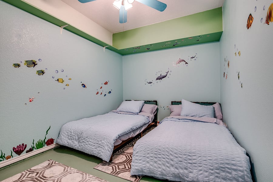 Bedroom 4, with 2x twin beds, ceiling fan, smart tv, and walk-in closet
