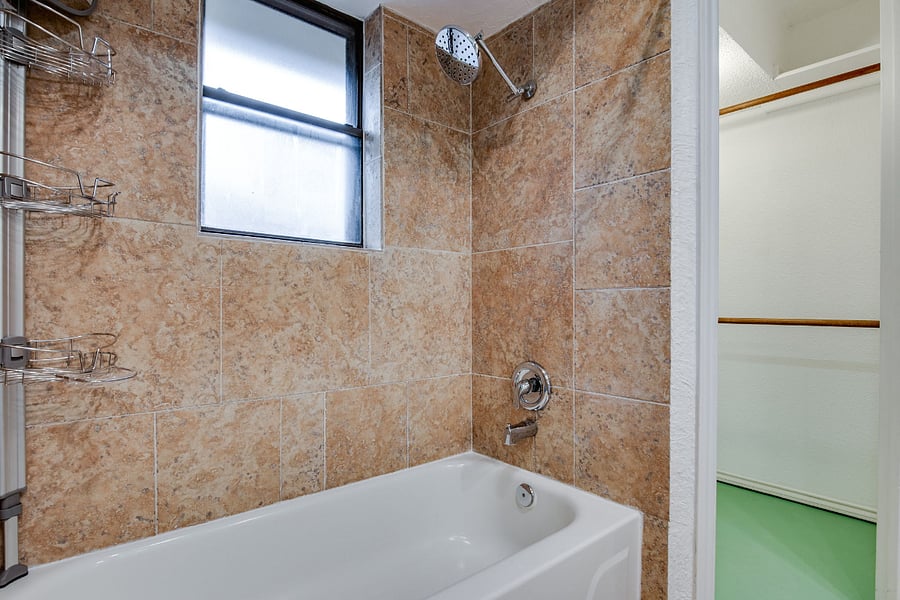 Master bathroom, with 2 sinks, tub,, shower, and 2x walk-in closets