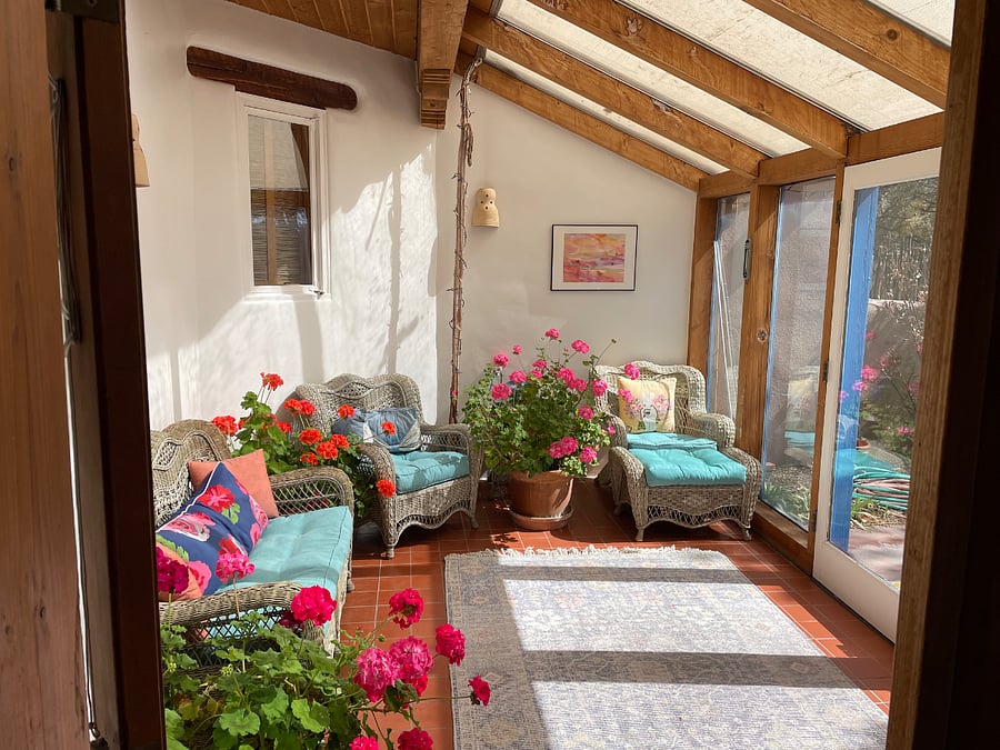 Sunroom off main entrance with flourishing geraniums