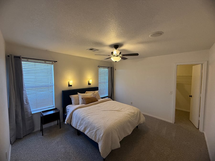 Large primary bedroom with spacious walk-in closet and ensuite bath