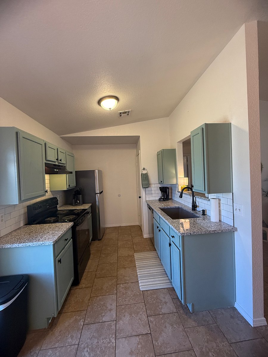 Kitchen fully stocked with granite counter tops and dishwasher (pantry opens across from the fridge)