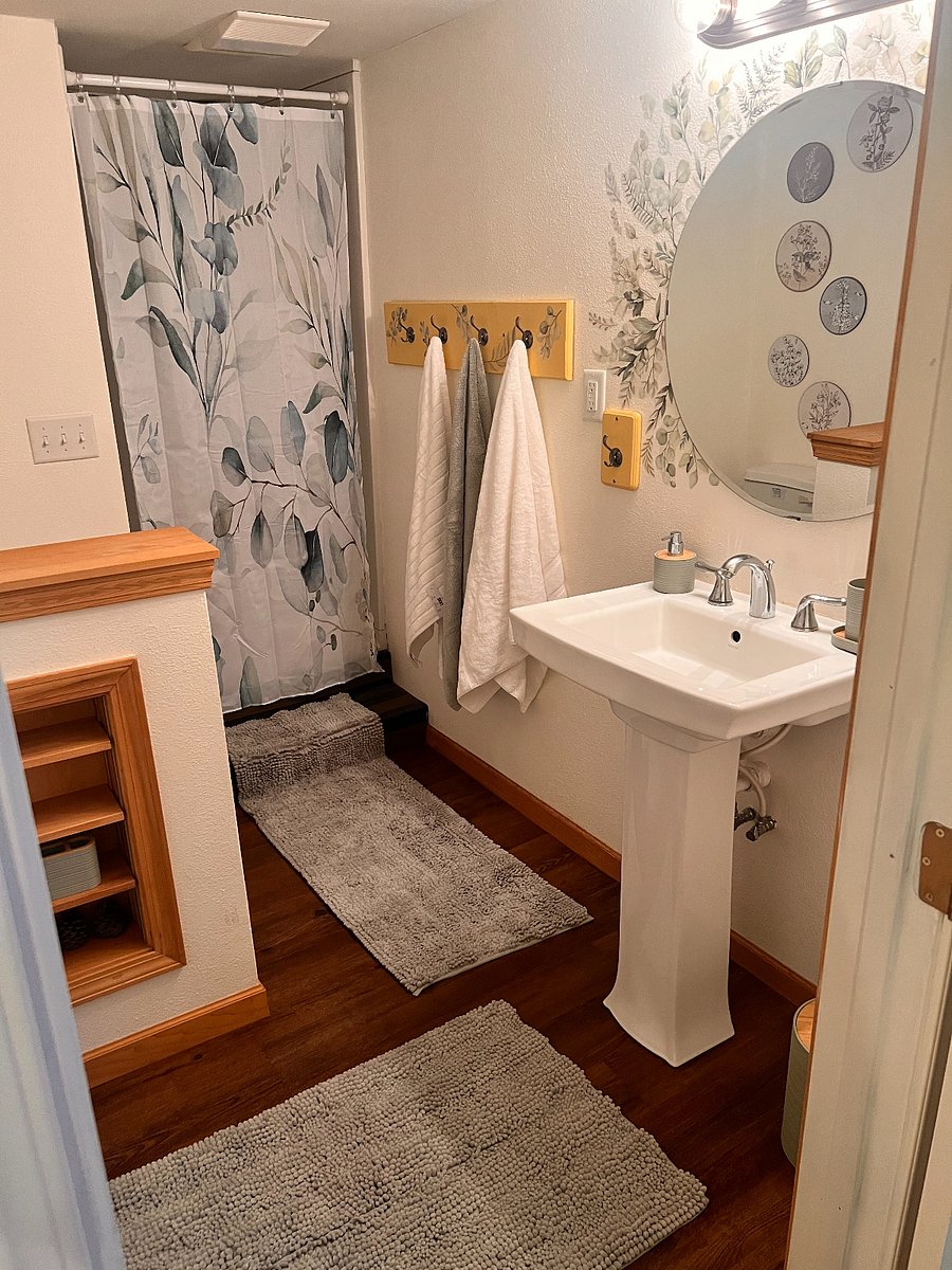 Private bathroom located by the master bedroom. Nature-themed decor for renters' relaxation