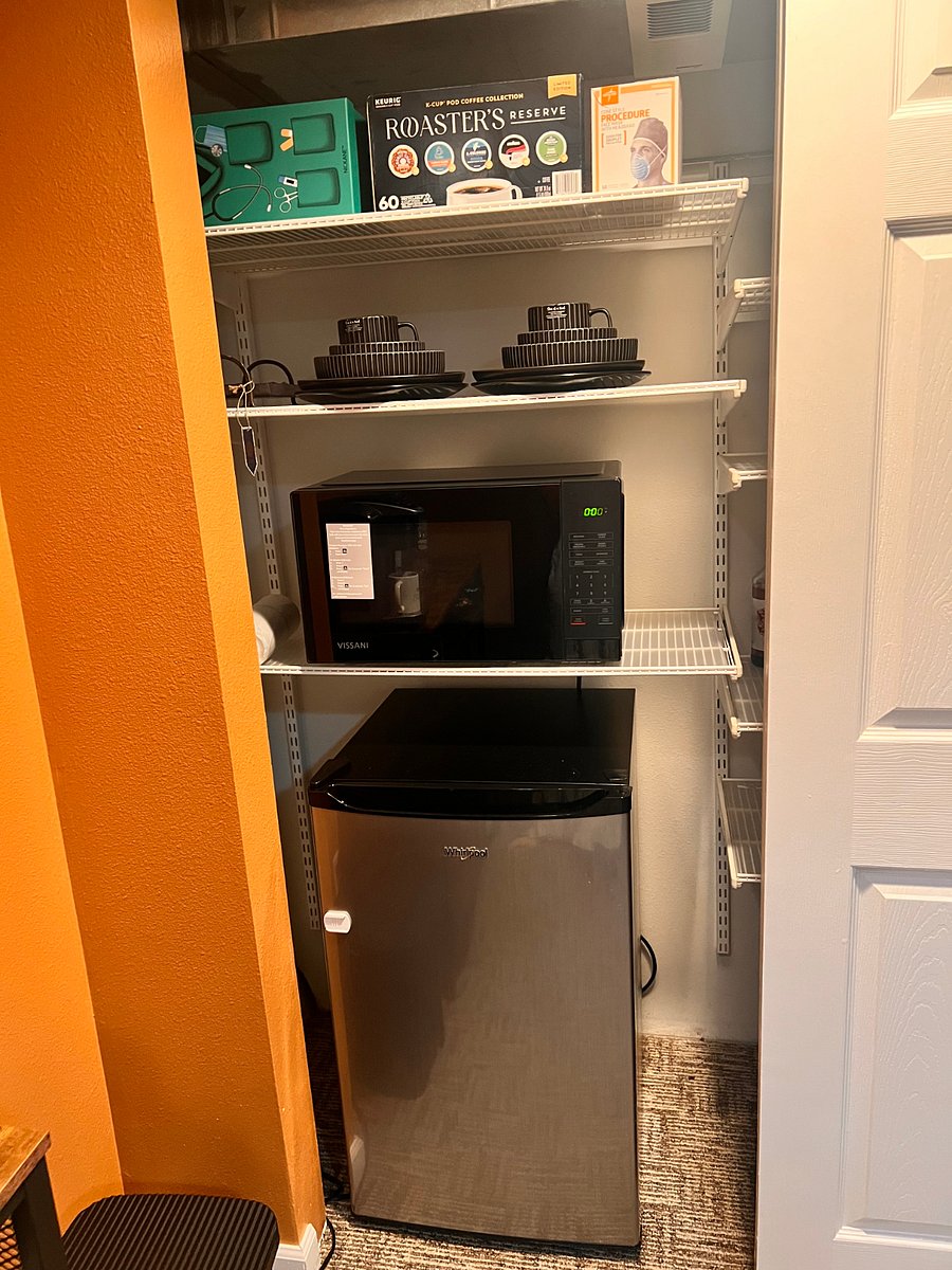 Brand-new microwave, hotel size refrigerator, plates, mugs, utensils,