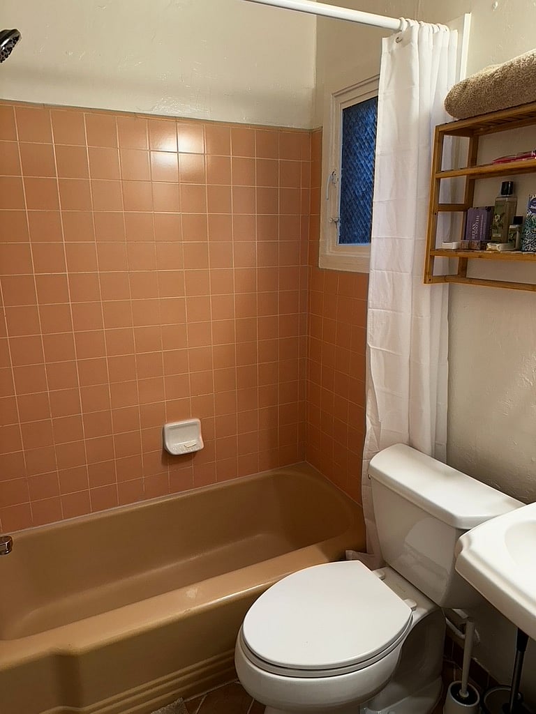 Bathroom with tile surround tub.