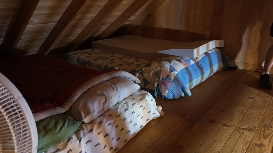 Up there you will find two queen-size floor mattresses, fully dressed with linens and pillows. There is also room for a desk for an additional workspace or maybe a comfy chair for reading.