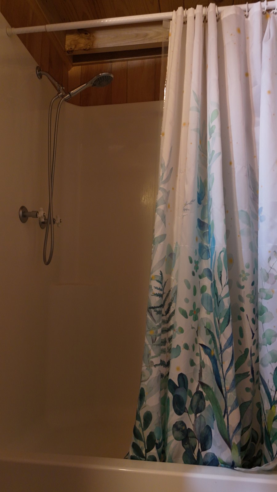 Your bathroom features a sweet shower with lots of water pressure, a handheld shower head and a seat.