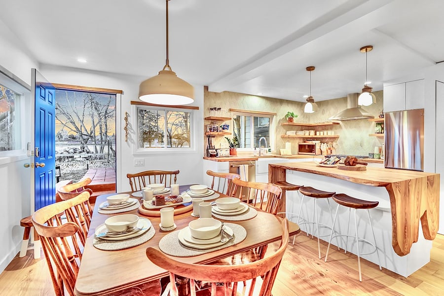 Antique farm table & chairs, dimmable lights, entrance light, and outlets under the kitchen island for convenience.