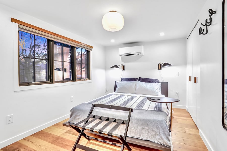 Organic queen memory foam mattress and organic cotton sheets, with blackout blinds, temperature control, shelves, and closet with hangers.